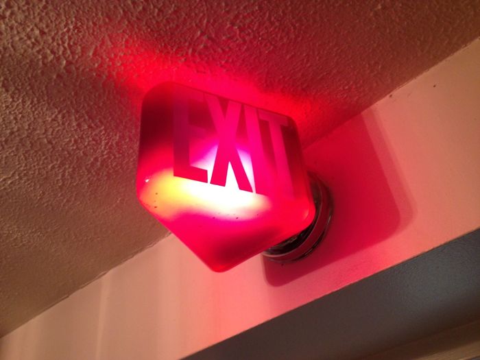 Older exit sign.
I was surprised to see this oldie exit sign still in use. There's a spiral lamp inside but this is meant for incandescent lamps. I can see a silhouette of the lamp's shape. The red is deeper in real life.
Keywords: Indoor_Fixtures