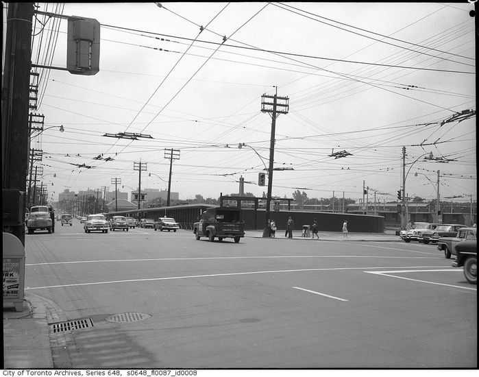 Yonge and Eglinton 
Taken around the late 50s - early 60s. Note the GE Type F electro-mechanic signal controller, the mixed 12-8-8 (top is a Crouse Hinds Type M, bottom are Eagle rodded Flatbacks. Also note the multiple incandescent Powerlite gumballs and the lack of pedestrian signals. 

 [url=https://maps.google.ca/maps?q=Eglinton+Station,+Toronto,+ON&hl=en&ll=43.706756,-79.398322&spn=0.00805,0.021136&sll=49.303974,-84.738437&sspn=14.883657,43.286133&oq=eglinton+s&hnear=Eglinton+Station&t=m&z=16&layer=c&cbll=43.706833,-79.398341&panoid=LL7BoMFiazNzvdp9efoKcw&cbp=12,201.74,,0,-7]Streetview[/url] of how it looks today. 
Keywords: American_Streetlights
