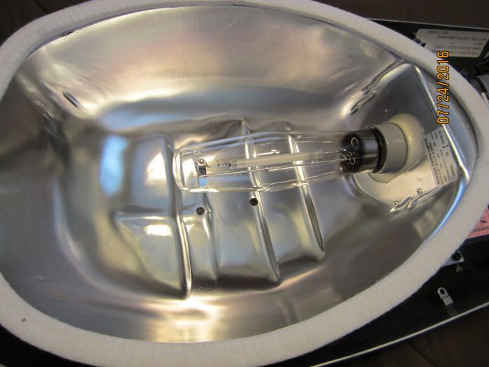 American Electric Lighting 125
Shown here is the reflector inside my AEL 125. Notice the dark gray porcelain lamp socket. It's different than a standard mogul socket found in HID fixtures as it has a spring loaded type center contact.
Keywords: American_Streetlights
