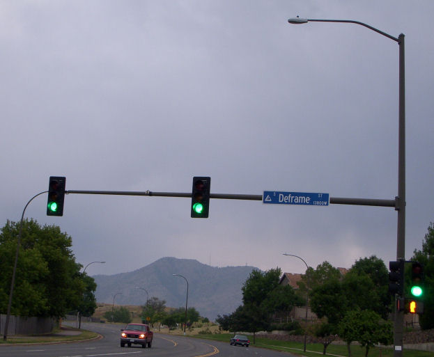 Typical Lakewood Traffic light setup.
This is the typical setup. With the weird one bend upsweep and the blue sign.

Not ALL of them are like this, Lots aren't; but this kind is the most common.

You can see an M-250r2 250w HPS light on that, With lots of davits in the background.
Keywords: American_Streetlights