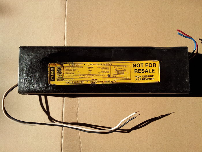 CGE 17A297E1 ballast from 03/90.
This week's harvest has been pretty good. Among all the incandescents I got, I also found a pair of fluorescent ballasts, including this one.

When I got it there was that large stain of tar covering the left part of the label. Today while packing some of my stuff I decided to try cleaning the label with Windex and an old toothbrush. To be honest I didn't expect it to work, but it did! I could remove 95% of the tar covering the label. A particular thing to note with late 80s CGE ballasts is the glossy paper they use for labels. The sort of gloss on the label makes it easy to clean!

The ballast is dated 03/90 and appears to work. I didn't test it but the primary reads 4.5 ohms, which sounds OK. I would have to test the secondary though.
Keywords: Gear